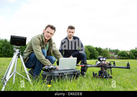 Engineers Using Laptop By UAV Helicopter Stock Photo