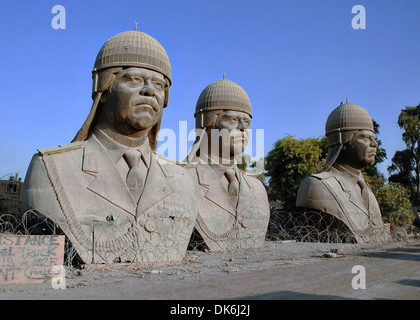 Thirty-foot tall bronze sculptures of former Iraqi dictator Saddam Hussein, sit on the grounds of the Republican Palace in the Green Zone December 20, 2005 in Baghdad, Iraq. The sculptures once sat atop the towers in the palace but were removed following the overthrow of the Saddam Hussein regime. Stock Photo