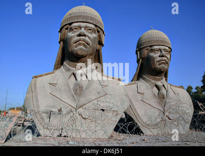 Thirty-foot tall bronze sculptures of former Iraqi dictator Saddam Hussein, sit on the grounds of the Republican Palace in the Green Zone December 20, 2005 in Baghdad, Iraq. The sculptures once sat atop the towers in the palace but were removed following the overthrow of the Saddam Hussein regime. Stock Photo