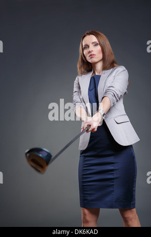 Studio portrait of a courageous and decided woman with golf club Stock Photo