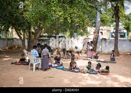 Rural Indian village school teacher and children in an outside class. Andhra Pradesh, India Stock Photo