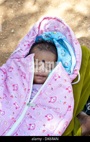 Sleeping Indian baby girl at Sathya Sai Baba mobile outreach hospital clinic in a rural Indian village. Andhra Pradesh, India Stock Photo