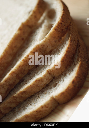 Slices of wholemeal bread (healthy loaf) ready for buttering Stock Photo