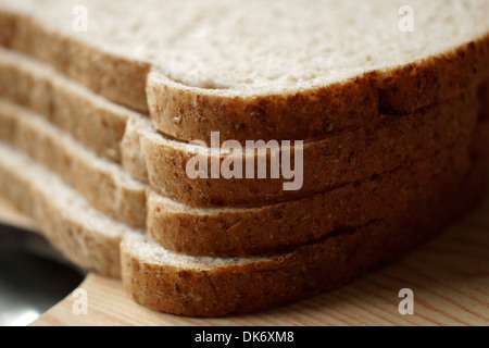 Slices of wholemeal bread (healthy loaf) ready for buttering Stock Photo