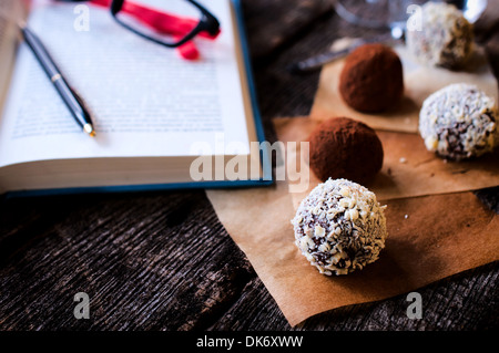 White chocolate pralines with nuts cream.Selective focus on the front right praline  Stock Photo