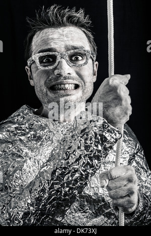 Crazy desperate alien man holding rope. Stock Photo