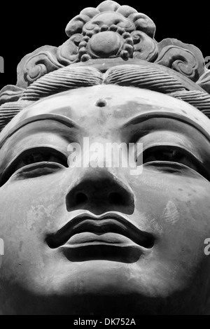 Black & White close up of one of the six 'The Offering of Six Devas' statues, surrounding the Tian Tan Big Buddha, Hong Kong. Stock Photo