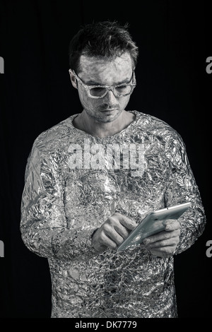 Portrait of spaceman using digital tablet. Stock Photo