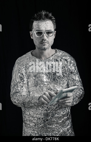 Portrait of spaceman using digital tablet. Stock Photo