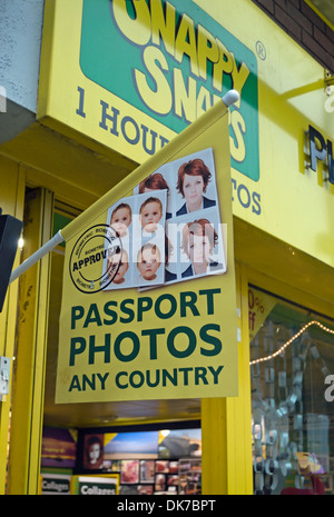 sign advertising passport photos for any country, at a branch of snappy snaps in kingston, surrey, england Stock Photo