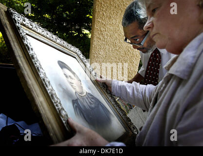 June 22, 2011 - Memphis, Tn, U.S. - June 16, 2011 - Along with June West (right) Lee Miller III looks at a portrait of what he hopes is his grandmother Willie Rosella Scott that was found tucked away in a hidden compartment in his families attic before the building was demolished. (Credit Image: © Mark Weber/The Commercial Appeal/ZUMAPRESS.com) Stock Photo