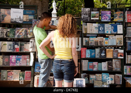 A tourist shopping for second hand books in the book market, Plaza de Armas square, Havana Cuba, Caribbean Stock Photo