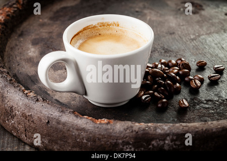 Coffee cup with coffee beans on dark background Stock Photo