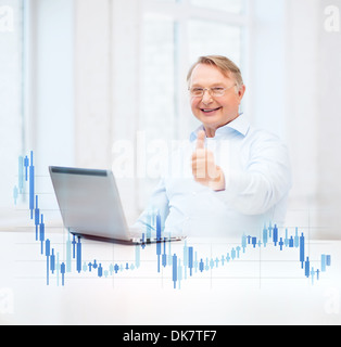 old man with laptop computer showing thumbs up Stock Photo