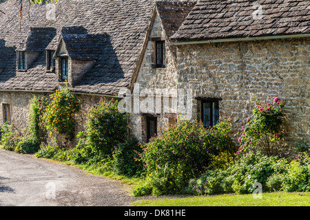 Part of the famous Arlington Row 14th century weavers' cottages in the Cotswold village of Bibury. Stock Photo