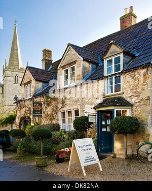 Craft shop and tea rooms in the historic Wiltshire village of Lacock with the spire of St.Cyriac's church behind. Stock Photo