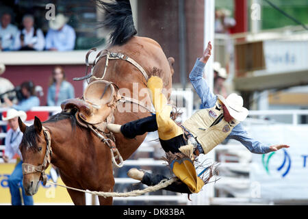 A cowboy gets bucked off a saddle bronc and loses his boot as he ...