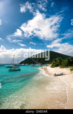The tropical sandy beach at White Bay on Jost Van Dyke in the British Virgin Islands in the Caribbean. The beach is a popular day stop for boaters. Known for its diverse marine life and coral reefs, the Caribbean region boasts some of the world's most beautiful and well-preserved beachscapes. Stock Photo