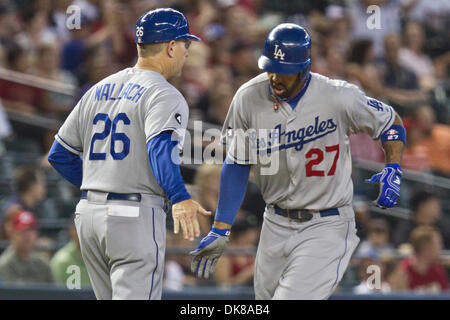 Los Angeles Dodgers center fielder Matt Kemp (27) is congratulated by Los  Angeles Dodgers third base coach Tim Wallach (26) as he rounds the third  base bag on his solo home run