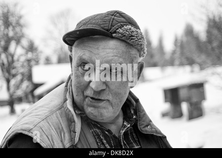 Man in a fur winter hat with ears smiling portrait on a background of a  winter forest Stock Photo - Alamy