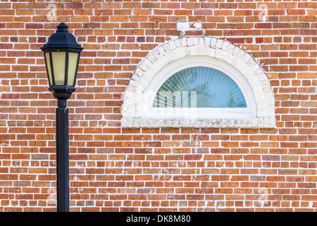 Street lamp post and arched window in old red brick window in historic downtown Green Cove Springs, Florida Stock Photo