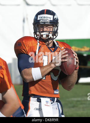 Denver Broncos quarterback Brady Quinn (9) watches counterpart Kyle Orton  throw the ball at football training camp for rookies at the team's facility  in Englewood, Colo., on Thursday, July 29, 2010. For