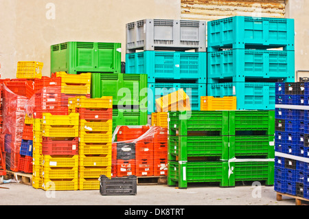 Colored stacks of fruits and vegetable crates in a storehouse Stock Photo