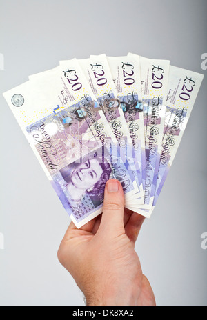 Hand holding five £20 notes Stock Photo - Alamy