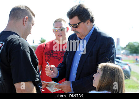 Aug. 12, 2011 - Watkins Glen, New York, U.S - NASCAR President Mike Helton (right) signs autographs for fans before the first practice for the Heluva Good! Sour Cream Dips at The Glen in Watkins Glen, NY. (Credit Image: © Michael Johnson/Southcreek Global/ZUMAPRESS.com) Stock Photo