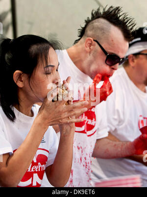 Aug. 20 2011 - Los Angeles, California, USA -  Sonya ''The Black Widow'' Thomas, the # 5 ranked eater in the world, and Pat Bertoletti, the # 2 ranked eater, compete in the gyoza (Japanese dumpling) eating contest at the annual Nisei Week Festival in downtown Los Angeles.  Thomas placed third with 209, and Bertoletti set a new Major League Eating world's record of 264 gyoza consume Stock Photo