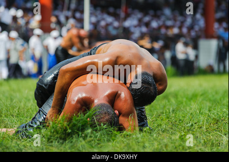Two wrestlers oil wrestling Turkish yagli güres in Kirkpinar Edirne Stock Photo