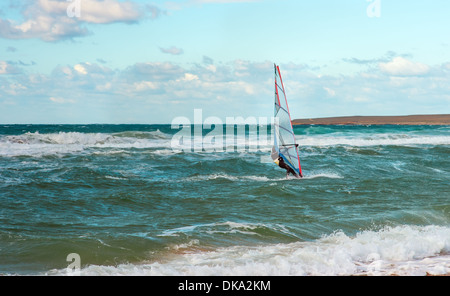 Sea Windsurfing Sport sailing water active leisure Windsurfer training on waves summer day Stock Photo