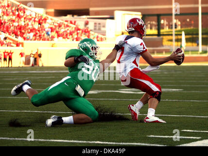 Sept. 10, 2011 - Austin, Texas, United States of America - Houston Cougars quarterback Case Keenum (7) tries to get free from North Texas Mean Green defensive tackle Ryan Boutwell (90) during the game between North Texas Mean Green and the Houston Cougars at Apogee Stadium in Denton, Texas. (Credit Image: © Matt Pearce/Southcreek Global/ZUMAPRESS.com) Stock Photo