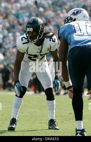 Jacksonville Jaguars' Rashean Mathis (27), left, is tackled by his hair by  Tennessee Titans' Jared Cook (89) on a return play during the second half  of an NFL football game in Jacksonville