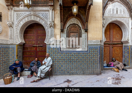 Men sitting outside Mosque Sidi Ahmed Tijani, The Medina, Fez, Morocco Stock Photo