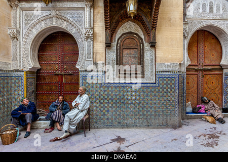 Men sitting outside Mosque Sidi Ahmed Tijani, The Medina, Fez, Morocco Stock Photo