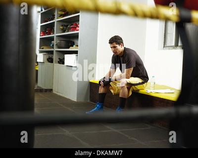 Boxer sitting in changing room Stock Photo