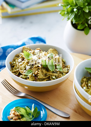 Bowl of farfalle pasta with herb garnish Stock Photo