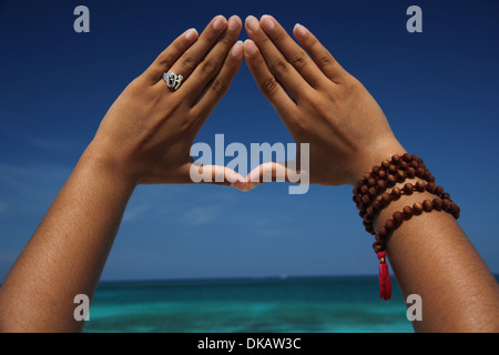 close up of hands making triangle paradise island nassau bahamas dkaw3c