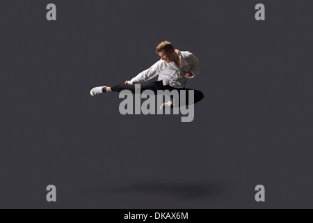 Studio shot of young man mid air practicing martial arts Stock Photo