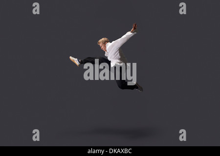 Studio shot of young man practicing martial arts Stock Photo