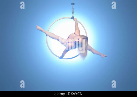 Female dancer balancing on hoop Stock Photo