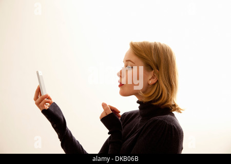 Woman reading message on cellular phone Stock Photo