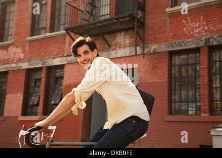 Portrait of young man on cycle, Los Angeles, California, USA Stock Photo
