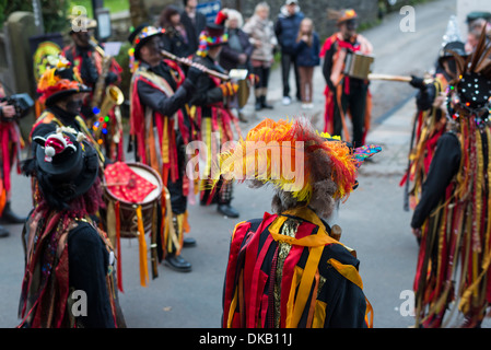 Morris Dancers  in bright colored costume performing in Castleton in Derbyshire England Stock Photo