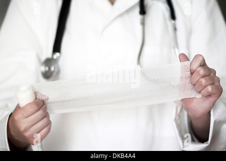 Close up studio shot of female doctor holding bandage Stock Photo