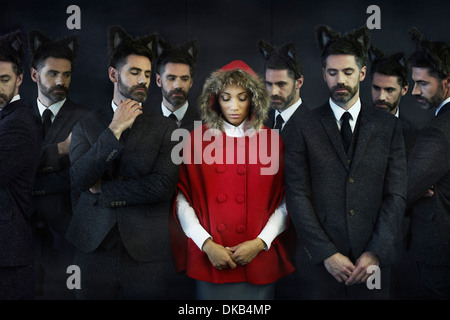 Woman dressed as little red riding hood with businessmen, multiple image