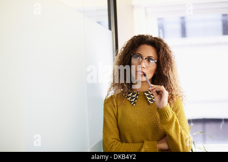 Female office worker holding pen Stock Photo