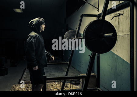 Weightlifter in dark gym Stock Photo