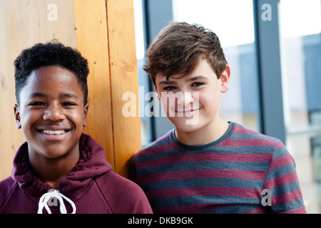Portrait of two teenage schoolboys in corridor Stock Photo
